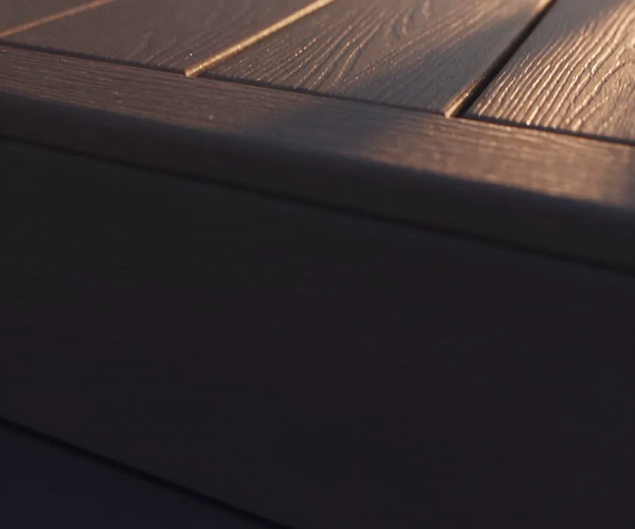Close-up of gray composite deck boards with a wood-grain finish